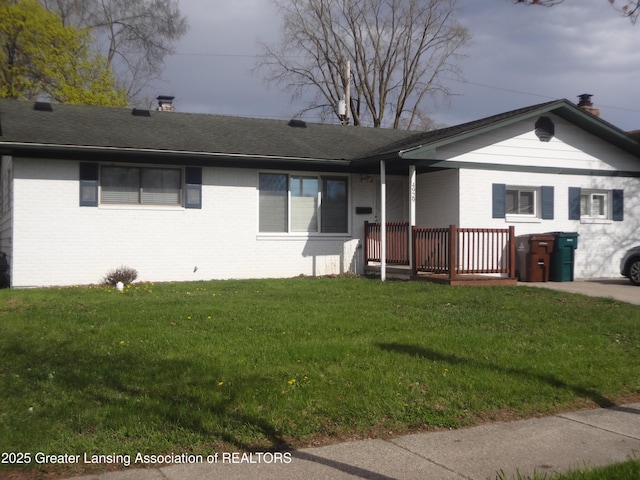 4929 Wainwright Ave, Lansing, MI 48911 - single story home featuring a chimney, brick siding, a front yard, and roof with shingles