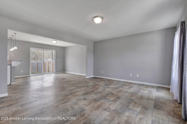 12001 Bryde Dr, Rives Junction, MI 49277 - spare room with baseboards and wood finished floors