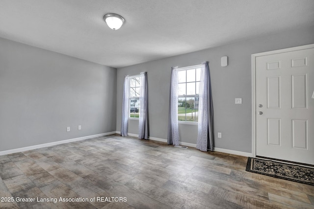12001 Bryde Dr, Rives Junction, MI 49277 - interior space featuring baseboards, wood finished floors, and visible vents