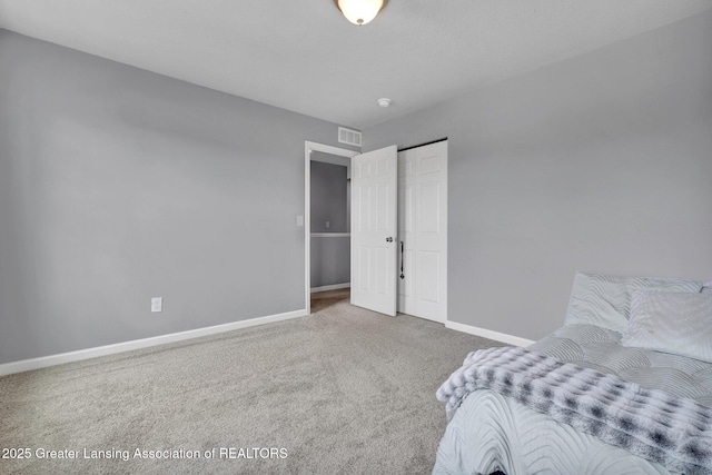 12001 Bryde Dr, Rives Junction, MI 49277 - bedroom with carpet floors, baseboards, and visible vents