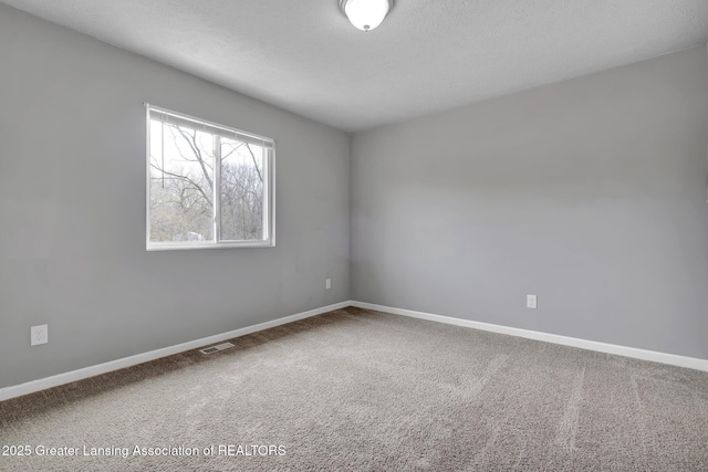 12001 Bryde Dr, Rives Junction, MI 49277 - empty room with visible vents, carpet flooring, and baseboards
