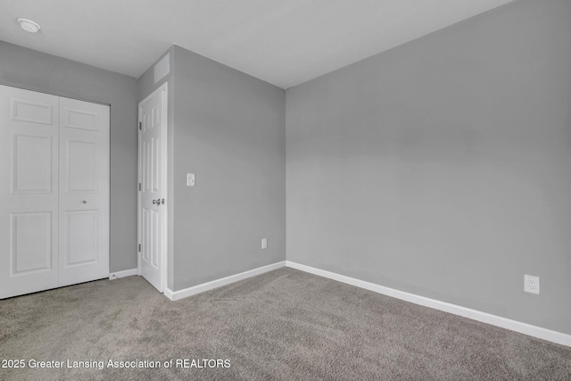 12001 Bryde Dr, Rives Junction, MI 49277 - unfurnished bedroom with baseboards, carpet, and a closet