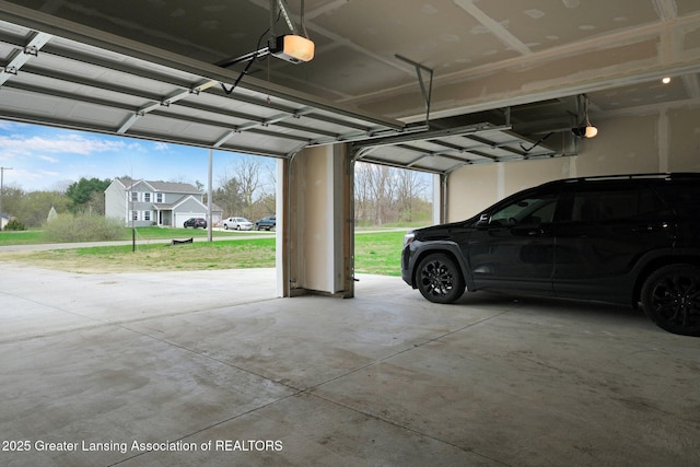 12001 Bryde Dr, Rives Junction, MI 49277 - garage featuring a garage door opener
