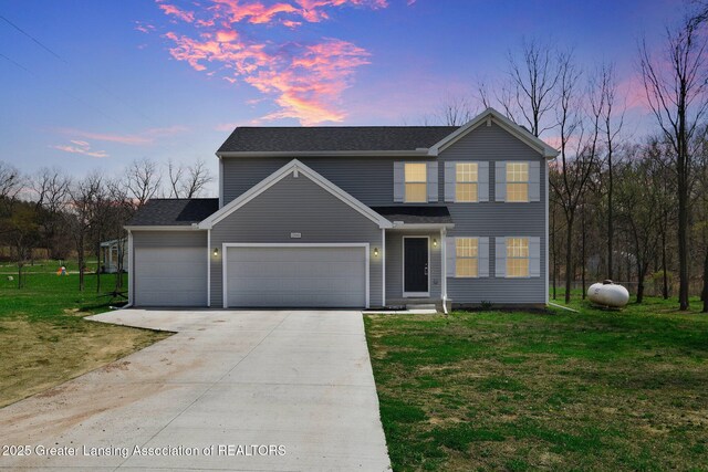 12001 Bryde Dr, Rives Junction, MI 49277 - traditional-style house with roof with shingles, an attached garage, a yard, and driveway