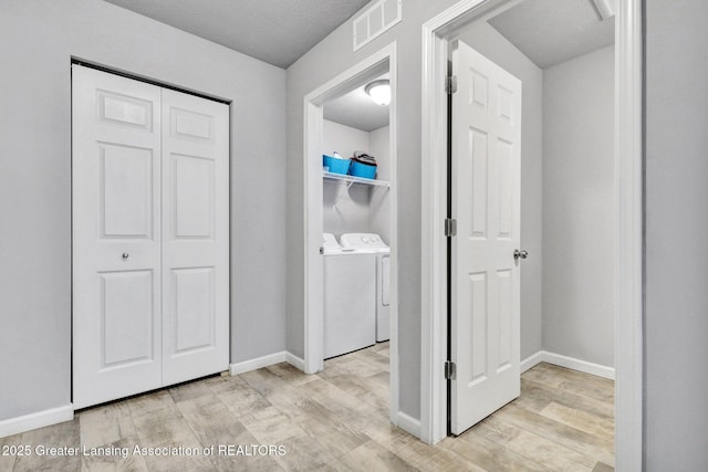 12001 Bryde Dr, Rives Junction, MI 49277 - corridor with independent washer and dryer, baseboards, visible vents, and wood finished floors