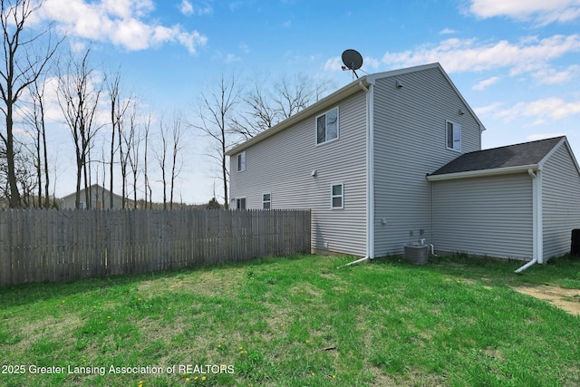12001 Bryde Dr, Rives Junction, MI 49277 - rear view of property with a yard, fence, and cooling unit