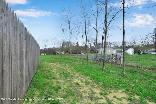 12001 Bryde Dr, Rives Junction, MI 49277 - view of yard featuring fence