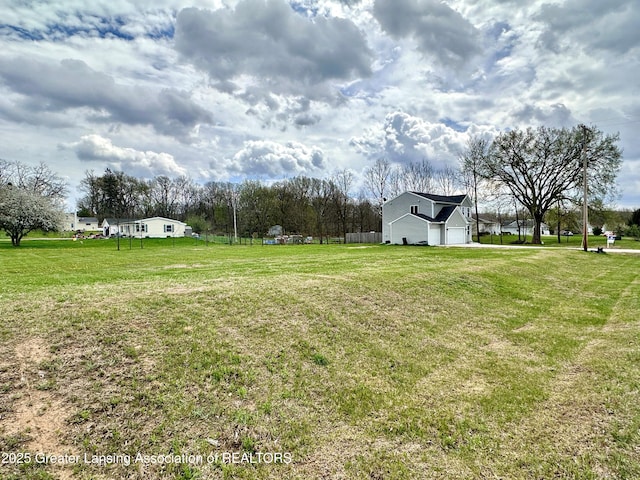 12001 Bryde Dr, Rives Junction, MI 49277 - view of yard with a garage