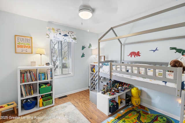 bedroom with wood finished floors and baseboards