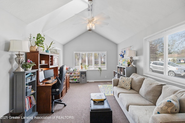 home office featuring a healthy amount of sunlight, a ceiling fan, vaulted ceiling, and carpet floors