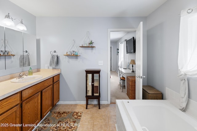 bathroom with vanity, tile patterned flooring, and tiled tub