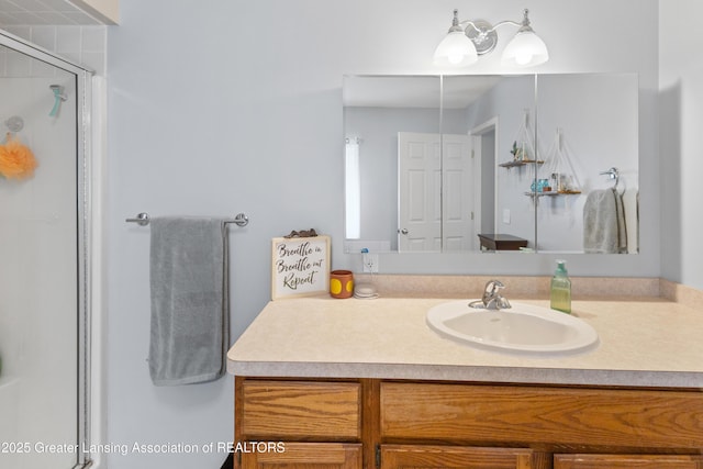 bathroom featuring vanity and a shower stall