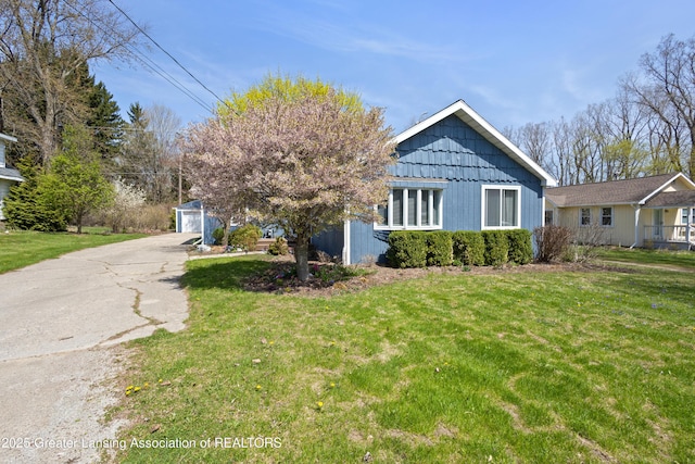view of front of house with a front yard and a garage