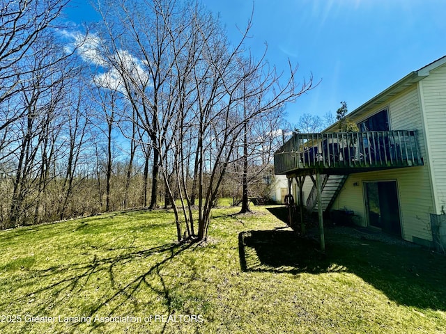 view of yard with a wooden deck and stairway