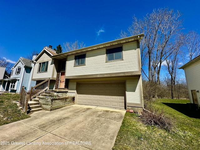 split foyer home with concrete driveway and a garage