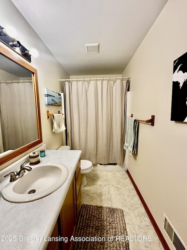 bathroom with visible vents, toilet, vanity, and marble finish floor