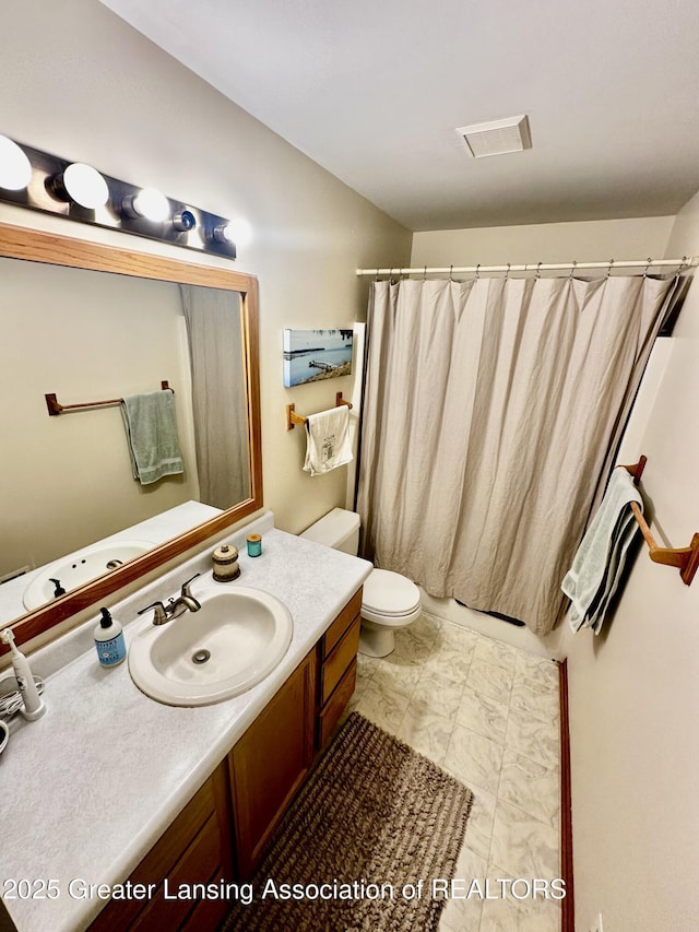 bathroom featuring vanity, curtained shower, toilet, marble finish floor, and visible vents