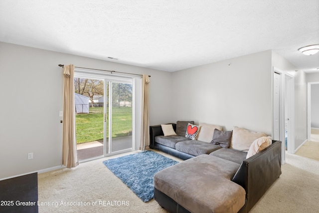 living room featuring baseboards, a textured ceiling, carpet, and visible vents