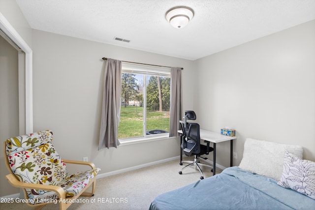 carpeted bedroom featuring baseboards and visible vents
