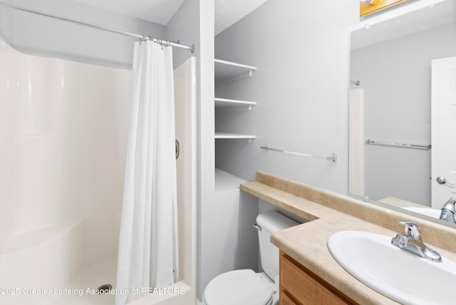 full bathroom featuring vanity, toilet, and a shower stall