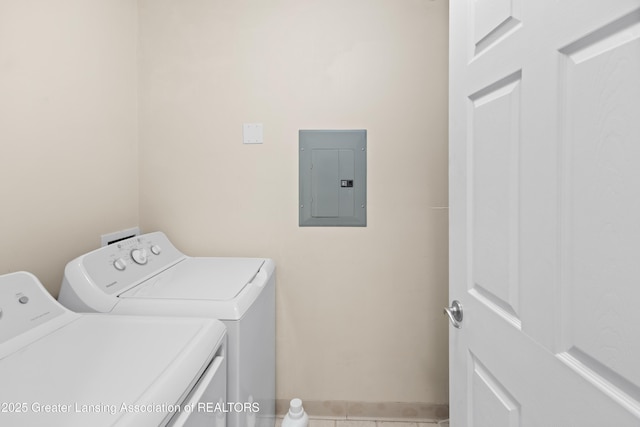 laundry room featuring laundry area, tile patterned flooring, baseboards, electric panel, and washing machine and clothes dryer