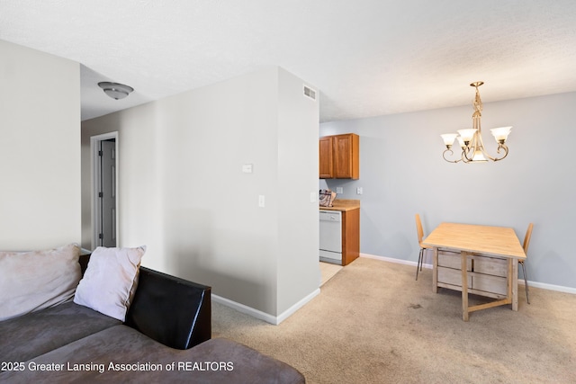 living room with an inviting chandelier, baseboards, visible vents, and light colored carpet