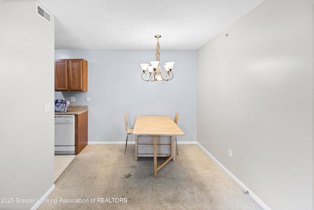 dining room featuring visible vents, baseboards, a notable chandelier, and light colored carpet