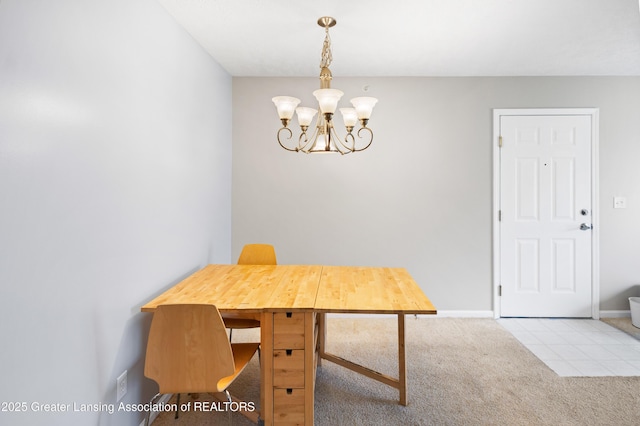 dining space with an inviting chandelier, baseboards, and carpet