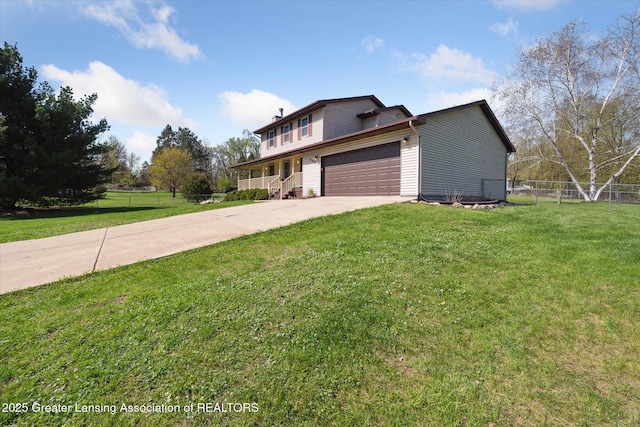 traditional home with fence, an attached garage, driveway, and a front lawn