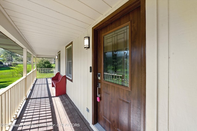 view of exterior entry with covered porch