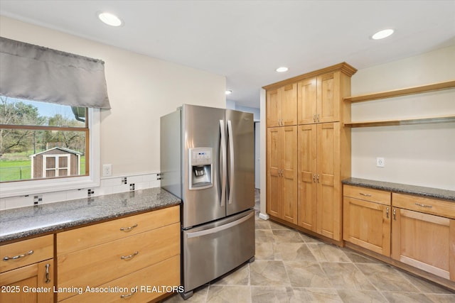 kitchen with stainless steel fridge, open shelves, dark stone countertops, and recessed lighting