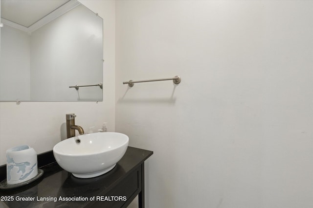 bathroom with crown molding and vanity
