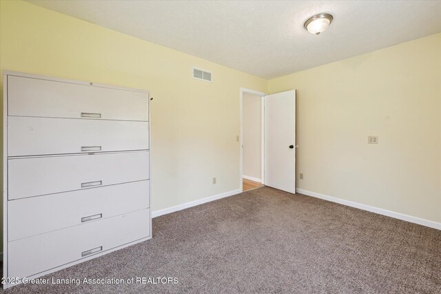 unfurnished bedroom with visible vents, baseboards, and carpet floors