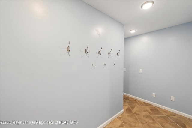 corridor featuring baseboards and recessed lighting