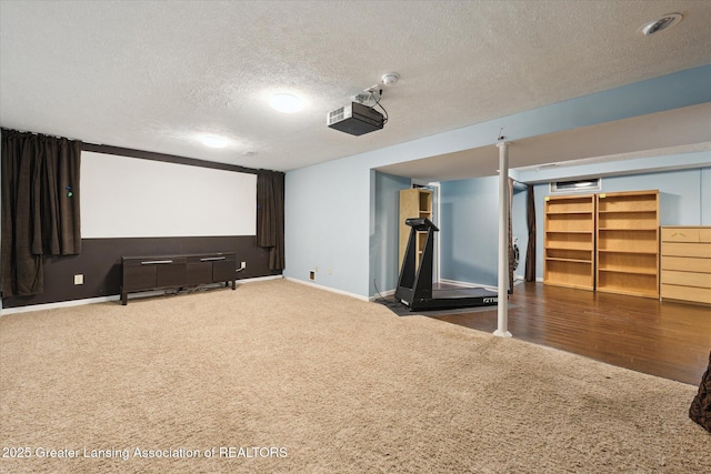 cinema with baseboards, carpet, and a textured ceiling