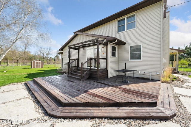 wooden terrace featuring a storage shed, a lawn, and an outdoor structure