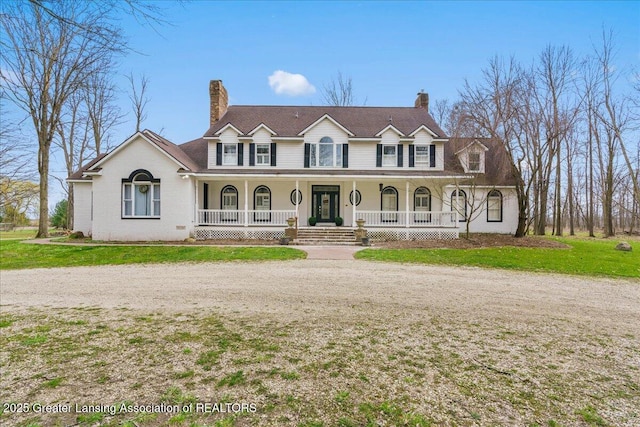 1785 N Williamston Rd, Williamston, MI 48895 - view of front facade featuring a front yard, covered porch, and a chimney