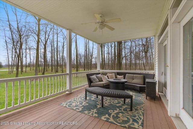 1785 N Williamston Rd, Williamston, MI 48895 - wooden deck featuring outdoor lounge area, a ceiling fan, and a lawn