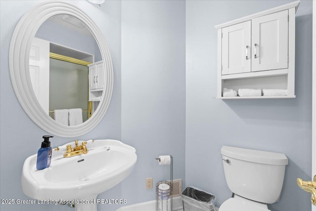 1785 N Williamston Rd, Williamston, MI 48895 - bathroom with a shower with shower door, toilet, and a sink