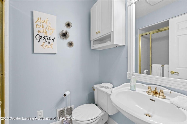 1785 N Williamston Rd, Williamston, MI 48895 - full bathroom featuring a shower stall, toilet, and a sink