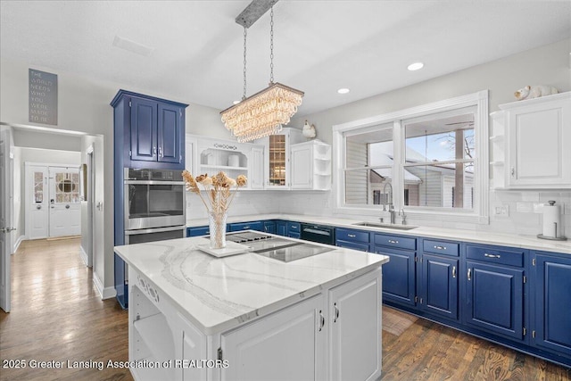 1785 N Williamston Rd, Williamston, MI 48895 - kitchen featuring tasteful backsplash, blue cabinets, open shelves, a sink, and a center island