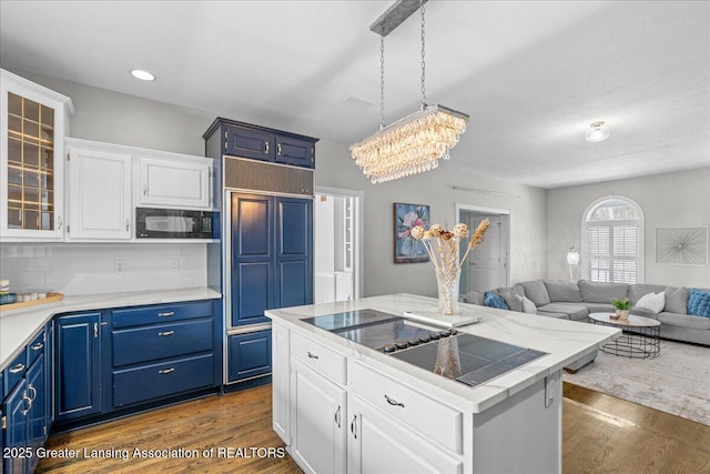 1785 N Williamston Rd, Williamston, MI 48895 - kitchen featuring white cabinets, glass insert cabinets, built in appliances, dark wood-style flooring, and blue cabinetry
