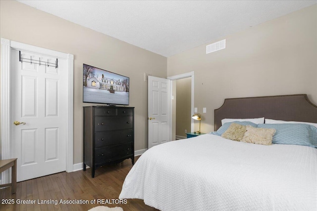 1785 N Williamston Rd, Williamston, MI 48895 - bedroom with visible vents, wood finished floors, and baseboards