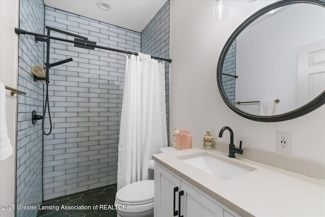 1785 N Williamston Rd, Williamston, MI 48895 - bathroom featuring vanity, toilet, and tiled shower