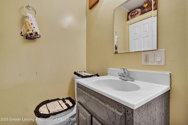 half bath featuring toilet and vanity