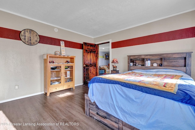 bedroom featuring ornamental molding, wood finished floors, and baseboards