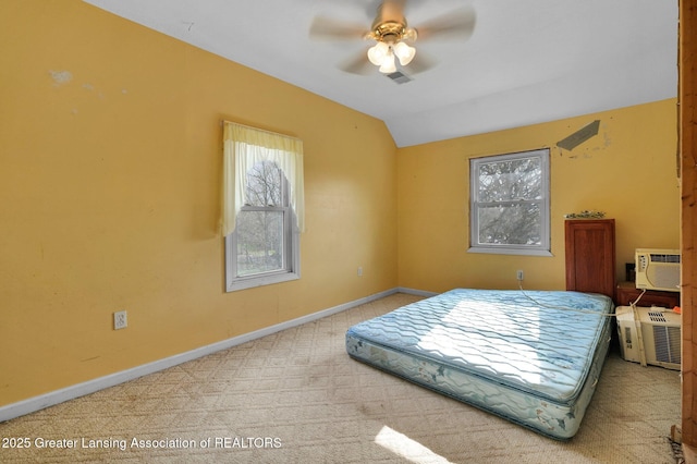 bedroom featuring visible vents, carpet, multiple windows, and lofted ceiling