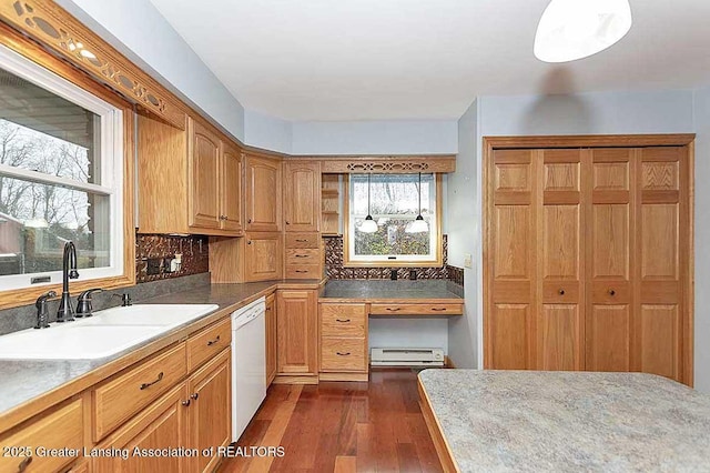 kitchen featuring tasteful backsplash, a sink, dishwasher, dark wood finished floors, and a baseboard radiator
