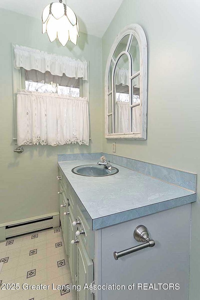bathroom featuring a baseboard heating unit and vanity