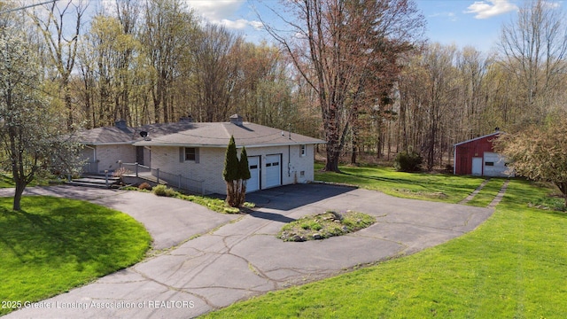 view of front of property featuring an attached garage, a front lawn, brick siding, aphalt driveway, and a chimney